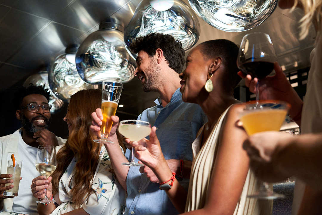 A group hangs out at the bar in Pink Agave.